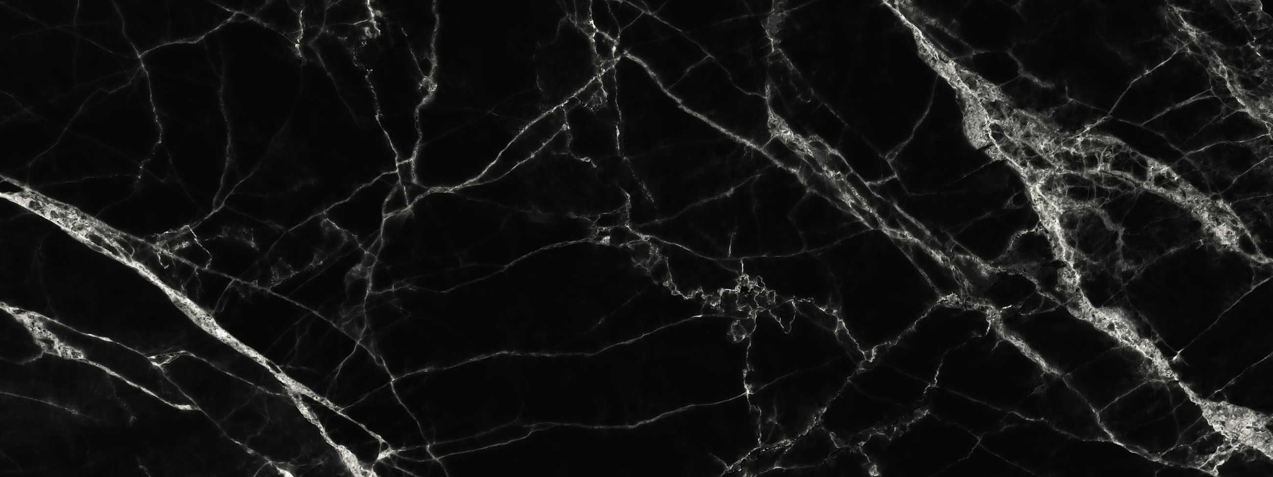 Black marble with white veining texture background.