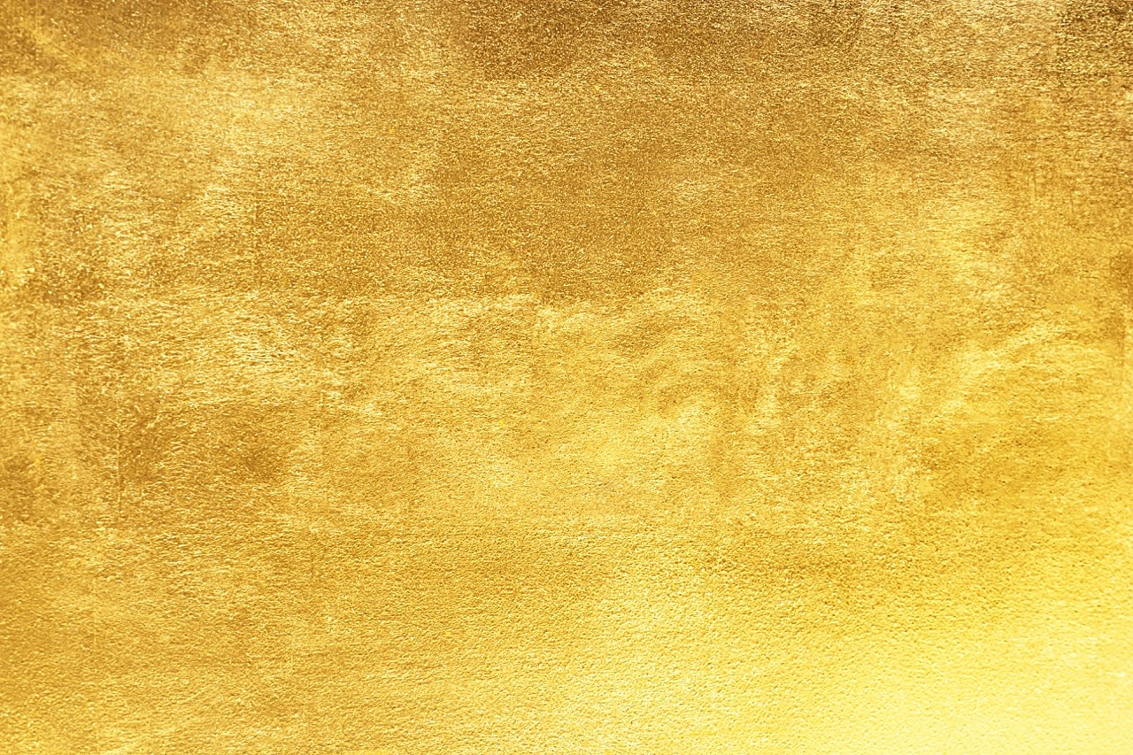 Textured gold background with metallic sheen.