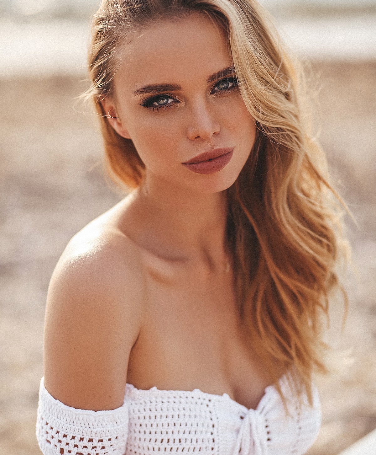 Close-up of a woman with wavy blonde hair.