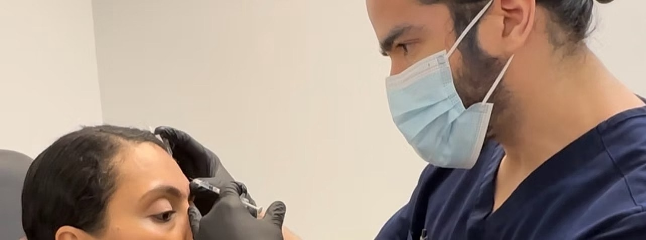 Eyebrow tattoo procedure in progress at clinic.